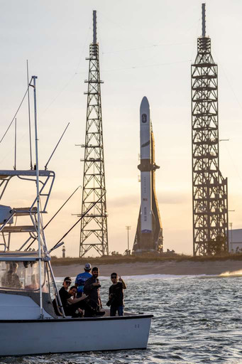 Close-up photo of the New Glenn rocket fully stacked on the pad from a Star Fleet boat nearby.